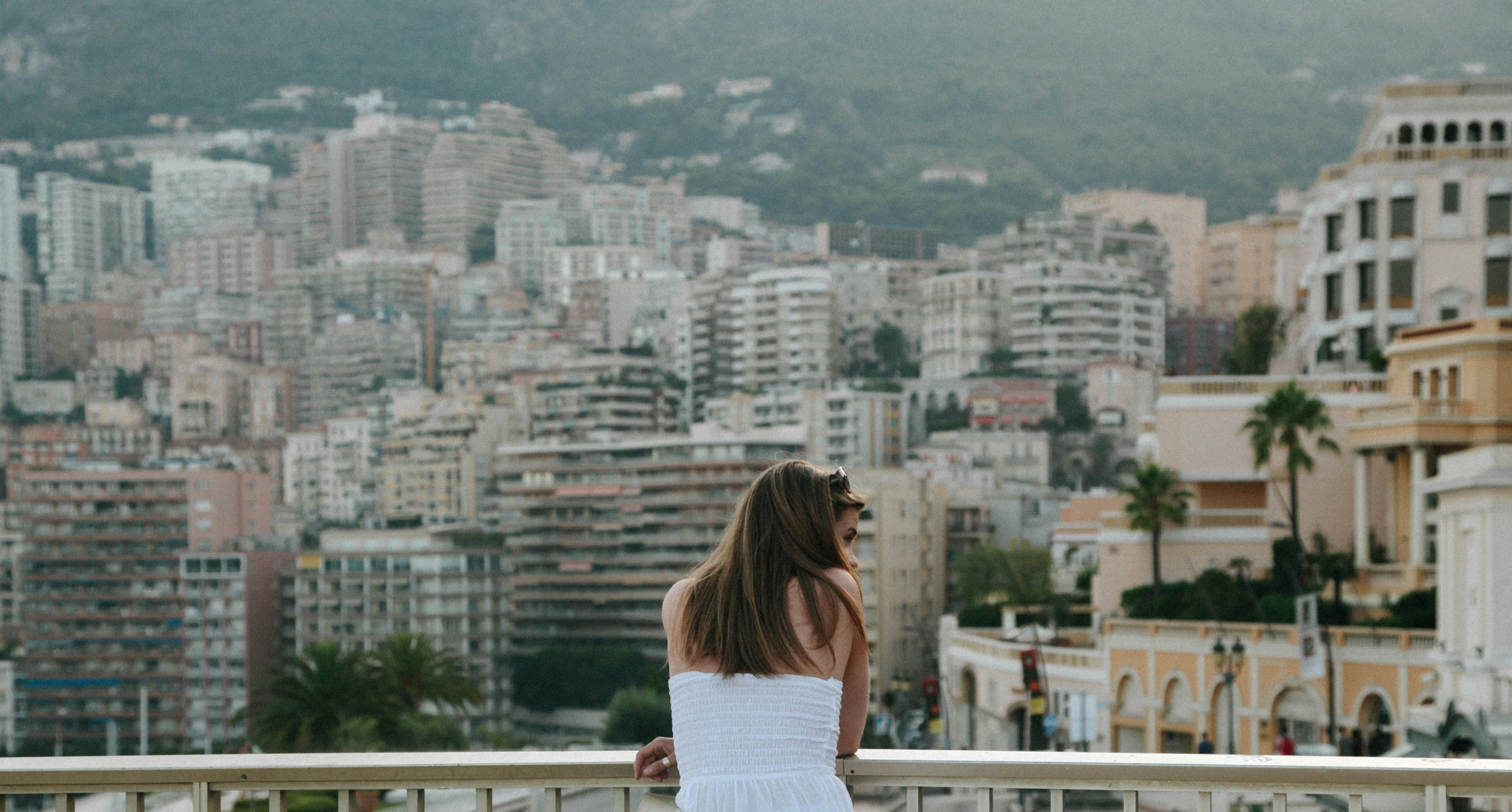 woman standing beside railings looking on her right